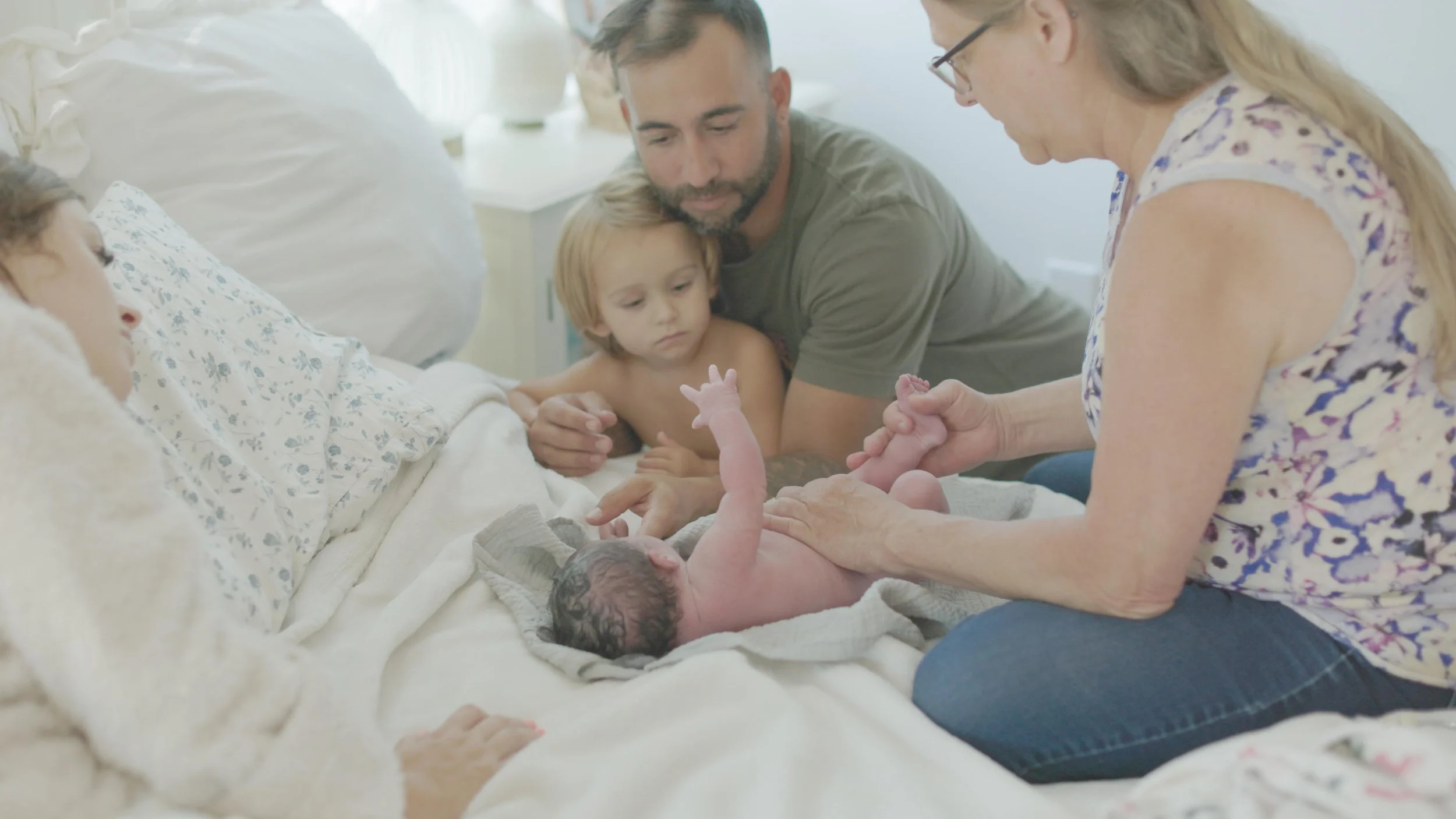 Mother holding her newborn after a home birth